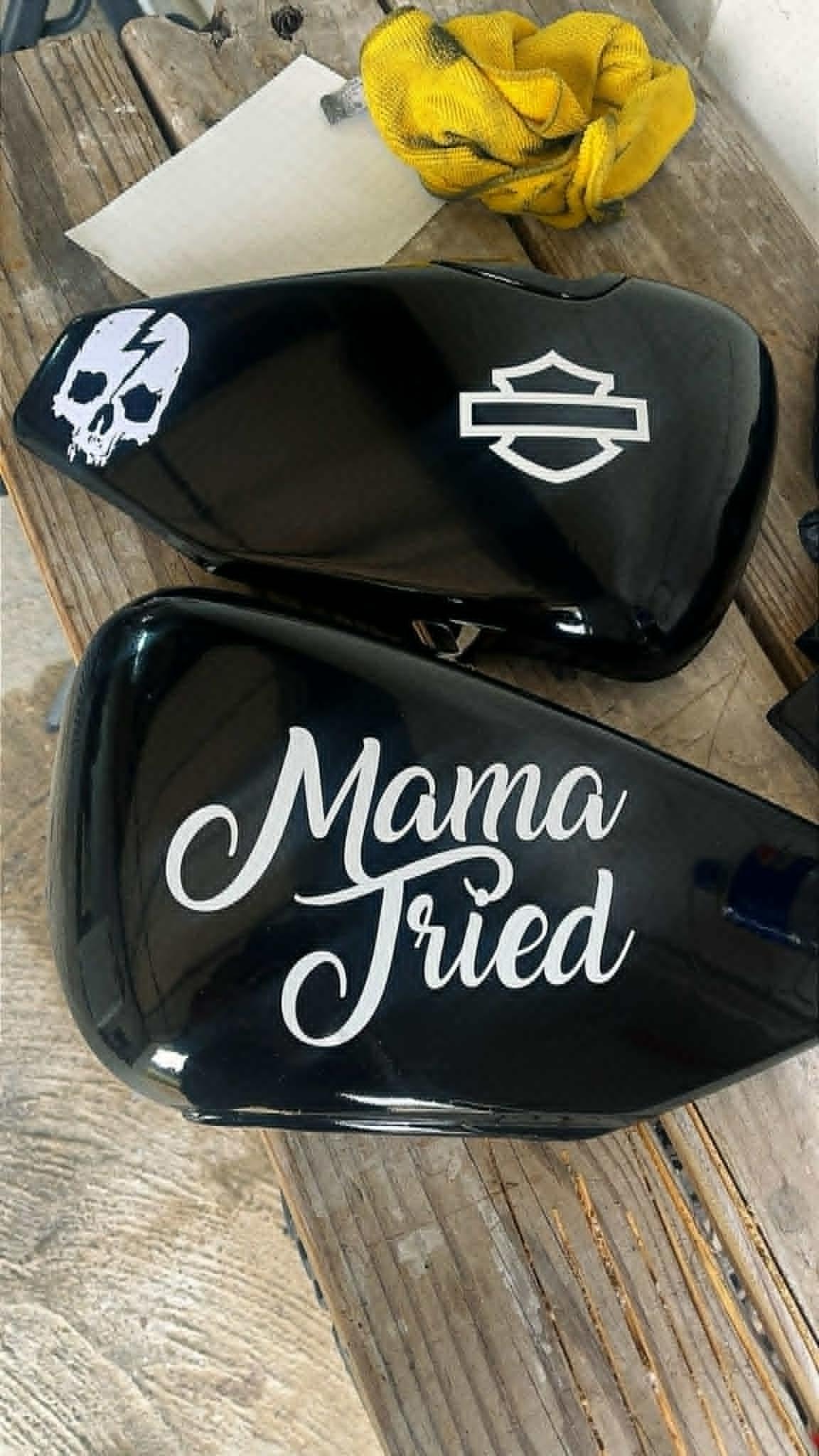 "Mama Tried" custom side covers — gloss black with skull-and-bolt and Harley shield