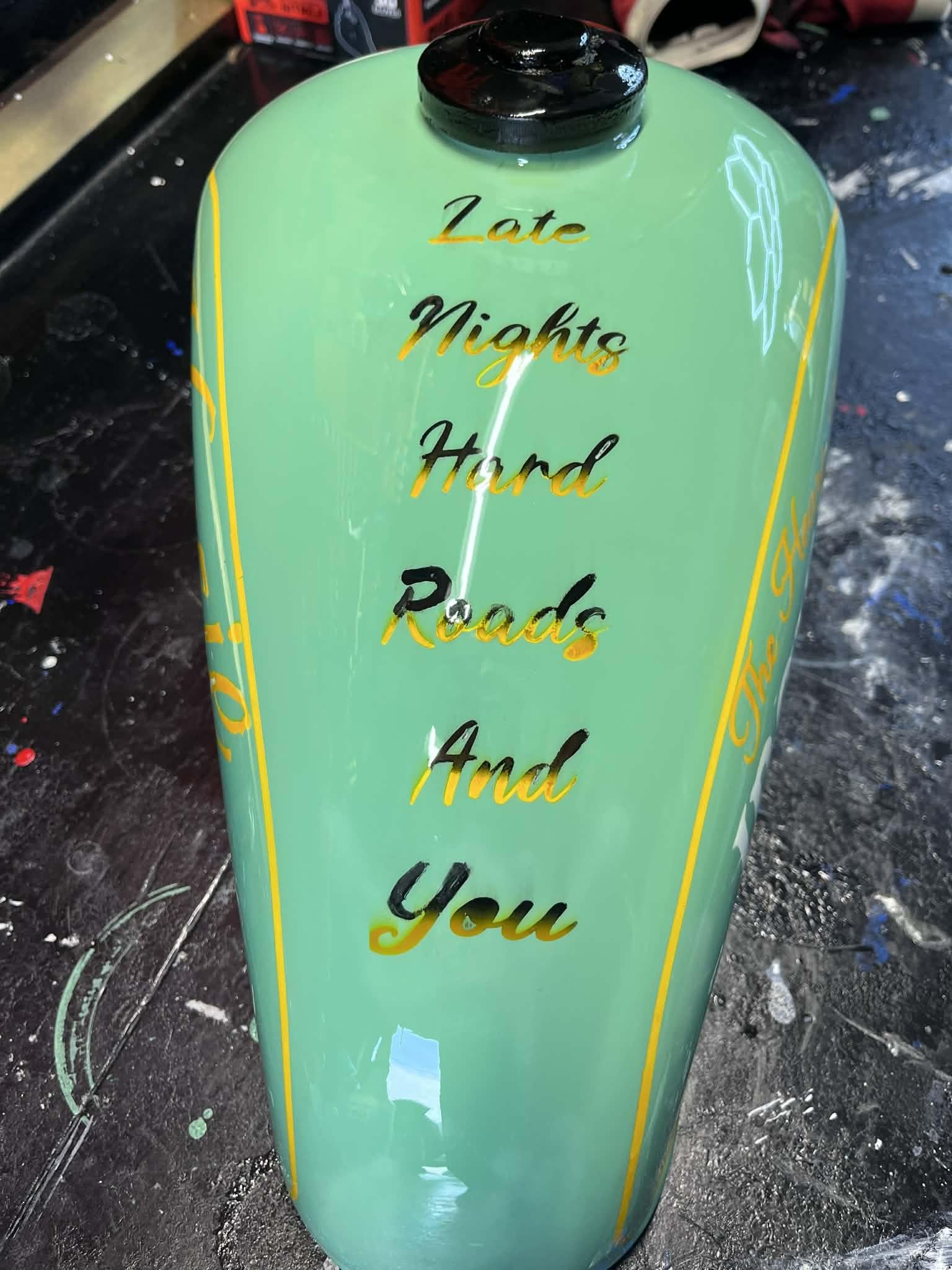 Lime-green custom tank with hand-painted cursive lettering
